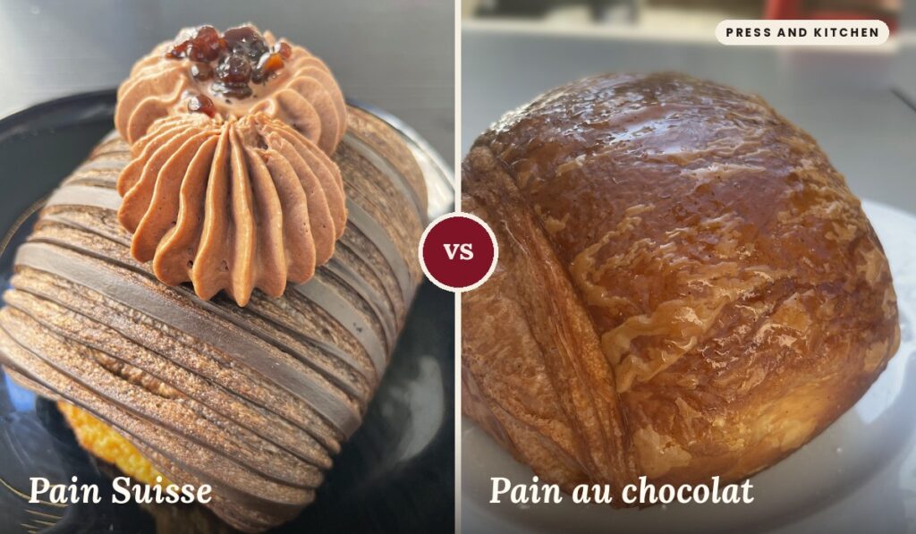 A sinistra, un Pain Suisse con sfoglia a strisce di cacao, decorato con due ciuffi di crema al cioccolato e piccoli cubetti di gelatina scura, su un piatto nero. A destra, un Pain au chocolat con la superficie dorata e lucida di glassa e la sfoglia stratificata ben visibile, su un piatto bianco.